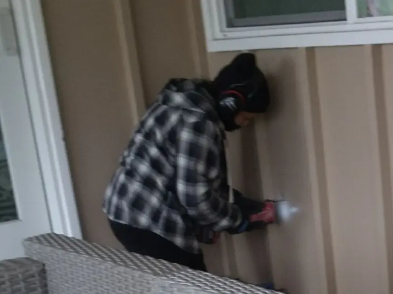 Professional electrician installing an exterior outlet in Grandy