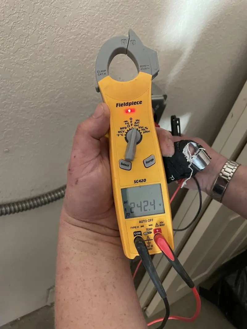 Voltage testing with clamp meter during Whole House Surge Protector in Grandy